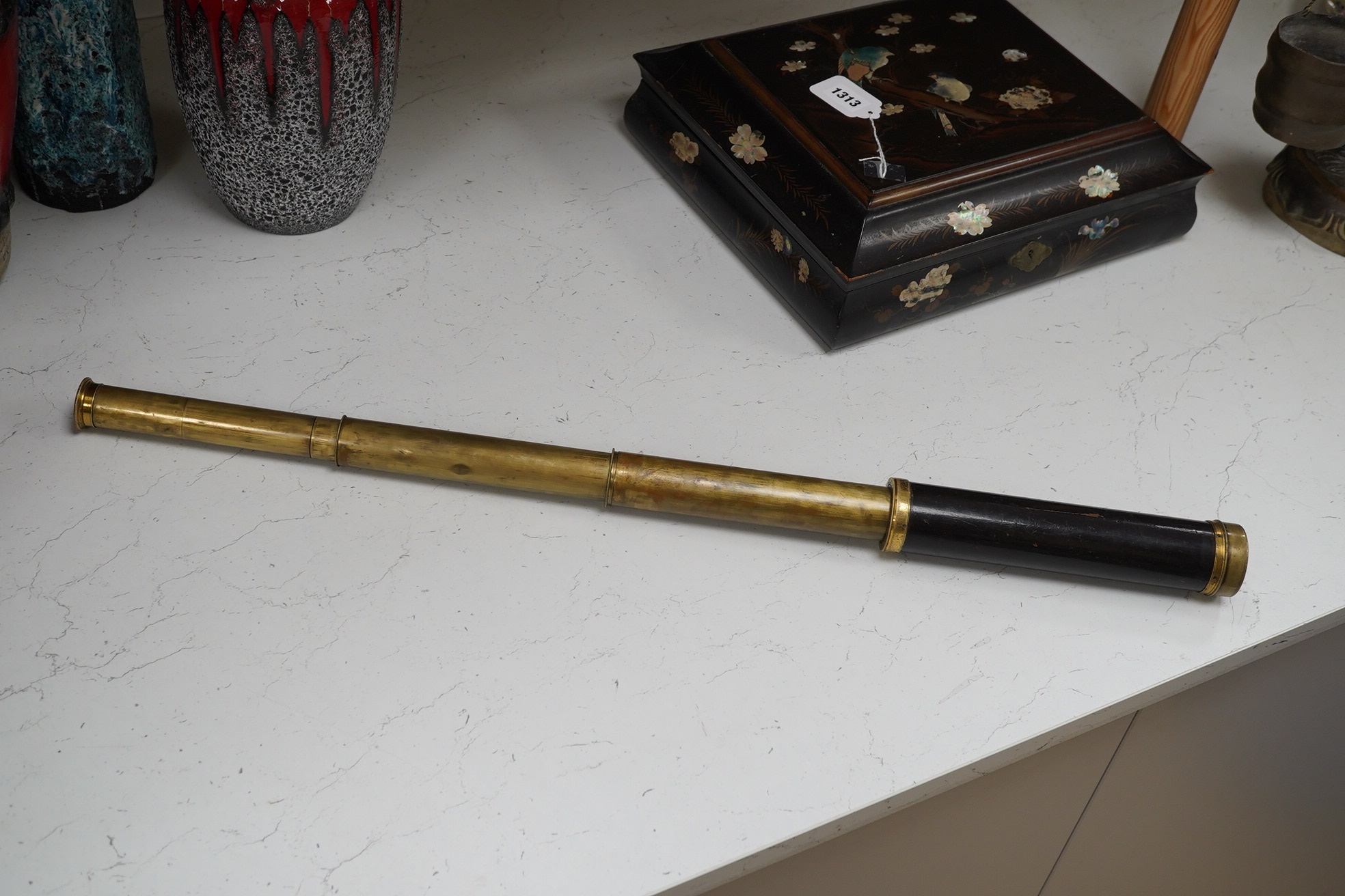 A leather cased Dolland three draw telescope, 72cm fully drawn. Condition - fair considering use